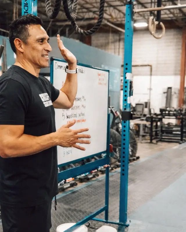 Coach Buffy Shoene speaking with a gym member during a training session at Live Active Charlotte