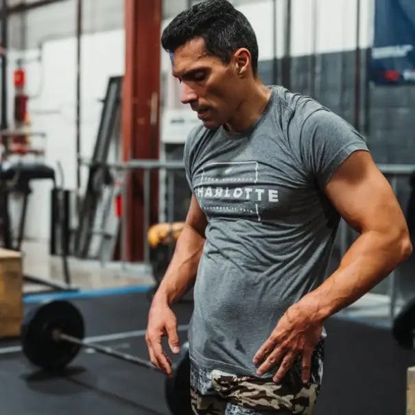 Personal trainer Jesus Gonzalez preparing for a strength training session inside a gym.