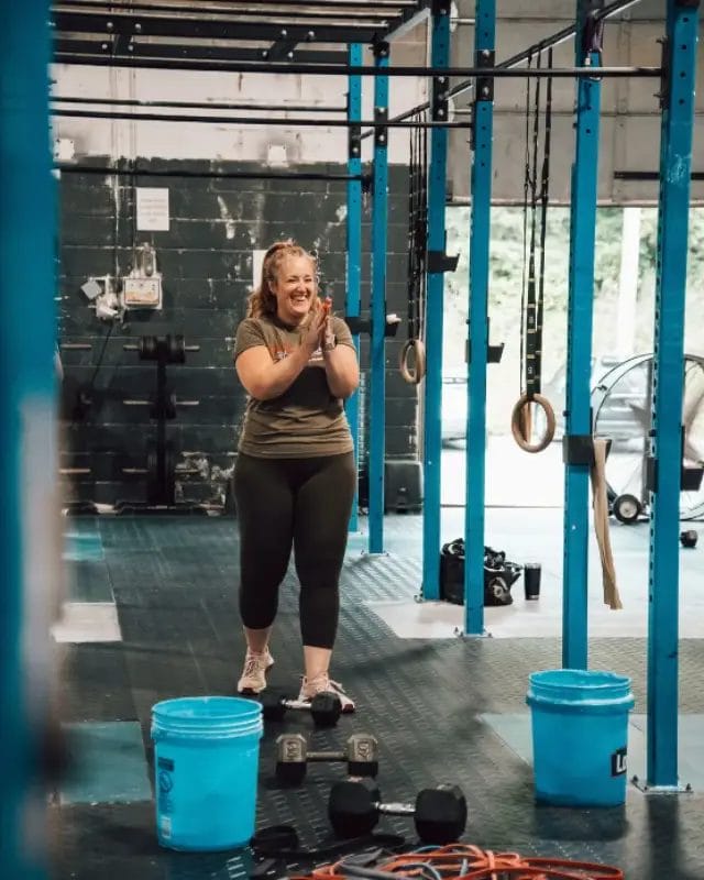 Coach Meri Faulkner leading functional training near gymnastic rings at Live Active Charlotte